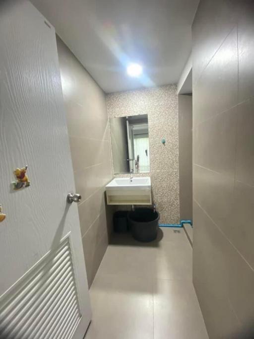 Modern compact bathroom with textured walls and sleek fixtures