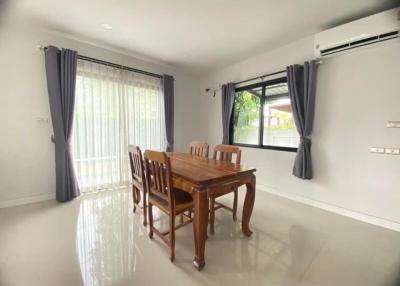 Spacious dining room with large window and elegant wooden table