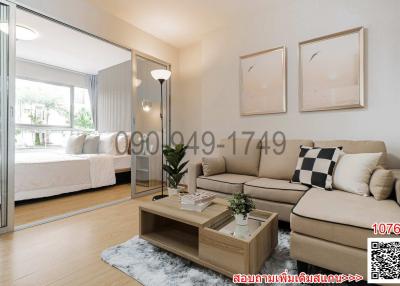 Spacious living room with modern furniture and an open layout leading to the bedroom