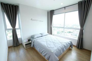 Spacious bedroom with large window and city view