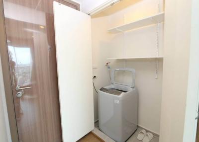 Compact laundry room with washing machine and built-in shelves