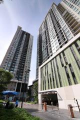 Modern high-rise residential buildings with entrance and clear sky