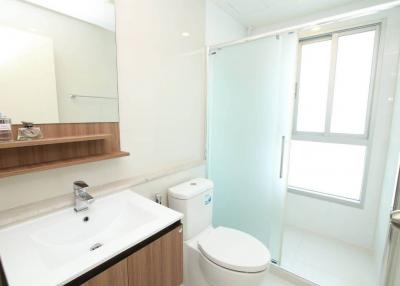 Modern white bathroom with shower cabin and natural light