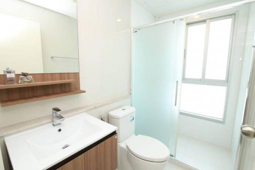 Modern white bathroom with shower cabin and natural light