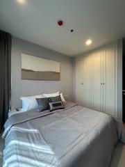 Modern bedroom with neutral tones and ample lighting