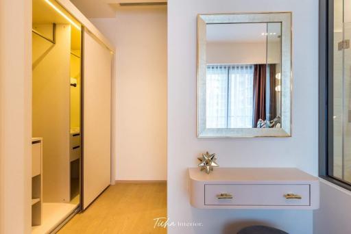 Modern bedroom interior with built-in closet and vanity