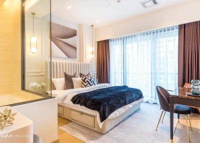 Modern styled bedroom interior with a comfortable bed, work area, and ample lighting