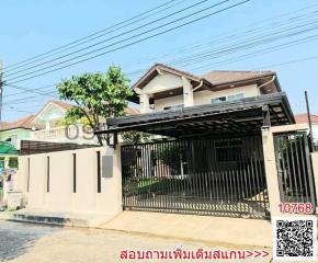 Exterior view of a residential house with gated entrance