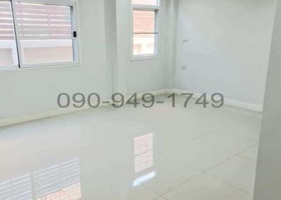 Bright empty room with glossy tiled floor and multiple windows