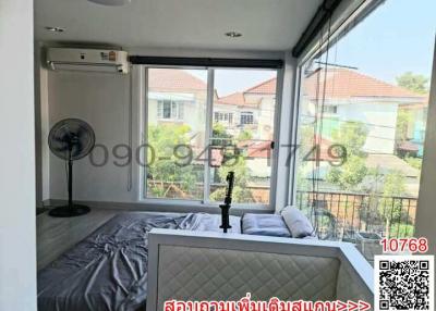 Bright bedroom with large window and modern air conditioner