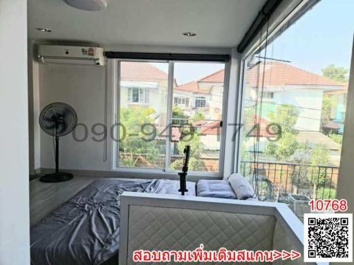 Bright bedroom with large window and modern air conditioner