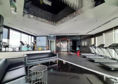 Modern gym with cardio machines and seating area