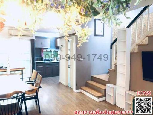 Open floor plan interior view featuring kitchen, dining area, living space, and staircase