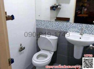 Compact bathroom with modern toilet and pedestal sink