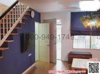 Cozy living room with staircase and wooden flooring