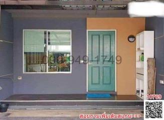 Front view of a residential building featuring entrance door and window