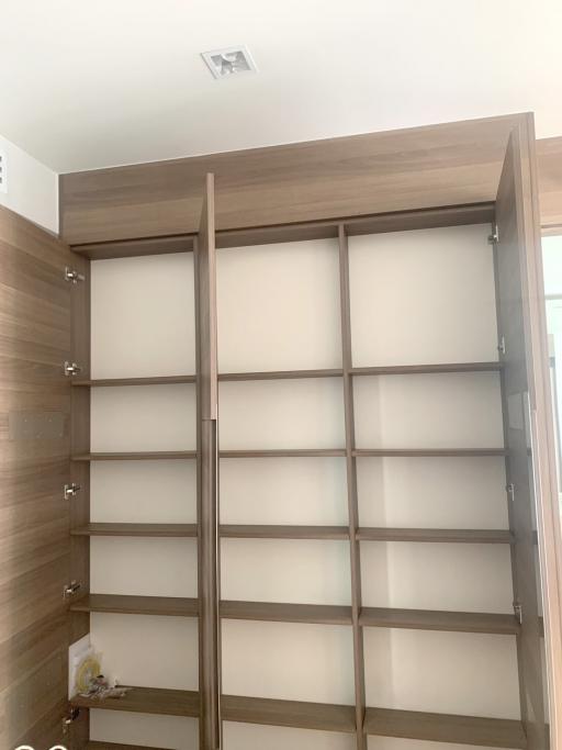 Empty wooden built-in closet with open shelves in a modern home