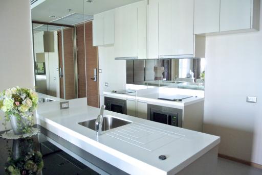 Modern kitchen with white cabinetry and built-in appliances