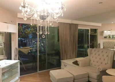 Spacious and elegant living room with modern chandelier and city view