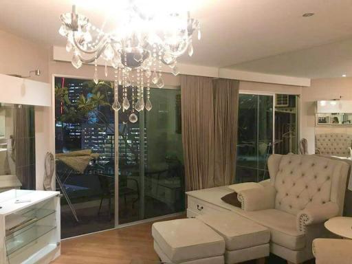 Spacious and elegant living room with modern chandelier and city view