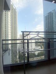 High-rise balcony with a view of surrounding buildings