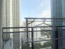 High-rise balcony with a view of surrounding buildings