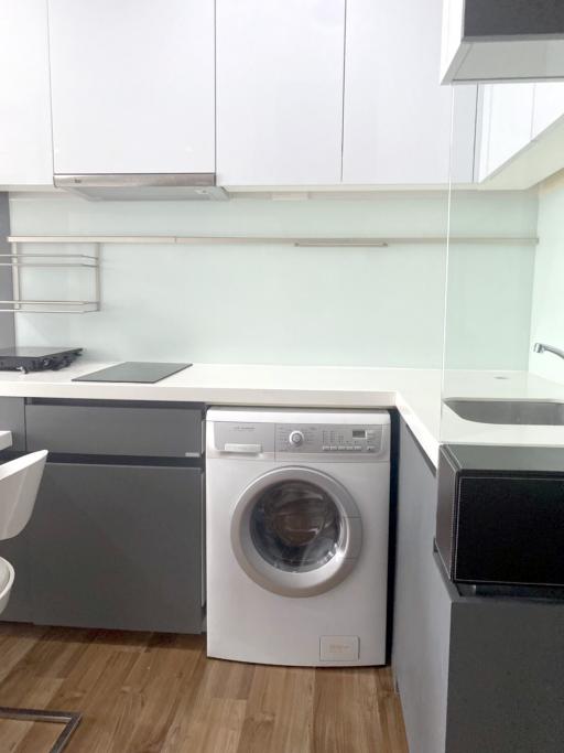 Modern kitchen with white cabinetry and built-in appliances