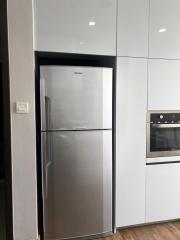 Modern kitchen with stainless steel refrigerator and built-in oven