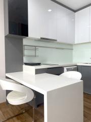 Modern kitchen with white cabinetry and built-in appliances