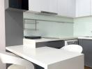 Modern kitchen with white cabinetry and built-in appliances