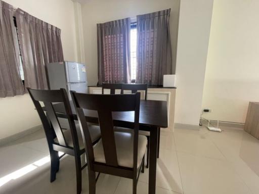 Spacious dining area with large window and modern furnishings