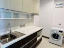 Modern kitchen with stainless steel appliances and white cabinets