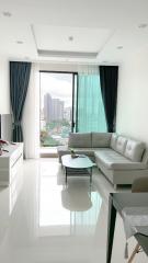 Modern living room with expansive city view through floor-to-ceiling windows