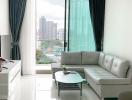 Modern living room with expansive city view through floor-to-ceiling windows