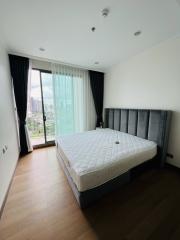 Modern bedroom with large window and city view