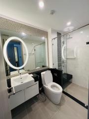 Modern bathroom interior with glass shower and LED mirror