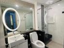 Modern bathroom interior with glass shower and LED mirror