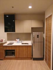 Modern kitchen with wooden cabinets and stainless steel appliances