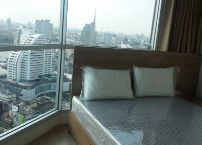 Modern bedroom with a view of the city skyline