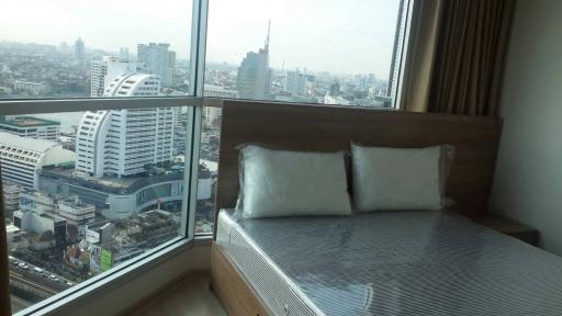 Modern bedroom with a view of the city skyline