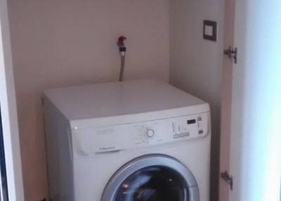 Compact laundry room with modern washing machine