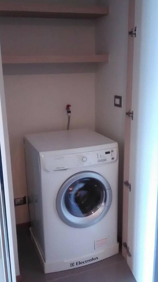 Compact laundry room with modern washing machine