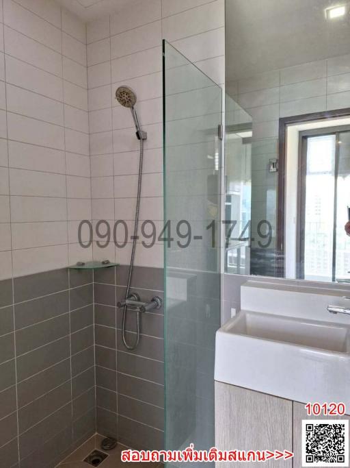 Modern bathroom with glass shower partition and wall-mounted showerhead