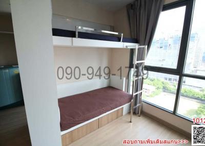 Compact bedroom with a bunk bed and city view