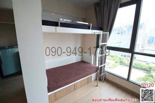 Compact bedroom with a bunk bed and city view