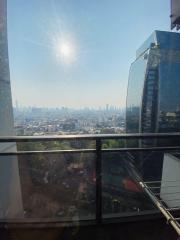 City view from high-rise apartment balcony with clear skies