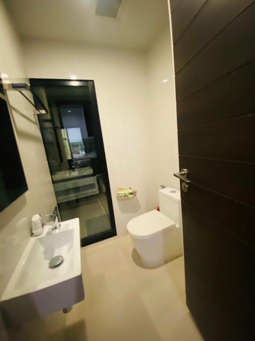 Modern compact bathroom with glass shower partition