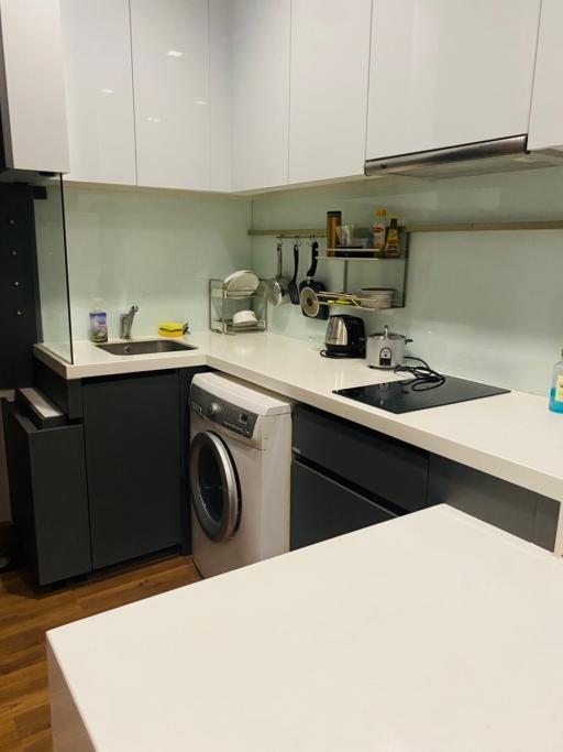 Modern kitchen interior with white countertops and appliances