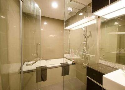 Modern bathroom with glass shower and well-lit mirror