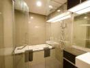 Modern bathroom with glass shower and well-lit mirror